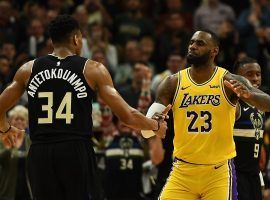 Milwaukee Bucks big man Giannis Antetokounmpo and LA Lakers star LeBron James dap before tipoff at Staples Center in Los Angeles. (Image: Kevork Djansezian/Getty)