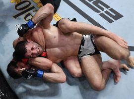 Islam Makhachev (bottom) continued his march up the UFC lightweight rankings by submitting Thiago Moises (top) on Saturday night. (Image: Jeff Bottari/Zuffa)