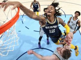 Ja Morant from the Memphis Grizzlies throws down a monstrous dunk over Jakob Poeltl from the San Antonio Spurs. (Image: Getty)