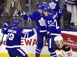 Â Andreas Johnsson (18) and Kasperi Kapanen (24) celebarte a goal from Toronto Maple Leafs center Auston Matthews (center) during a playoff game against the Boston Bruins. (Image: Frank Gunn/Canadian Press)