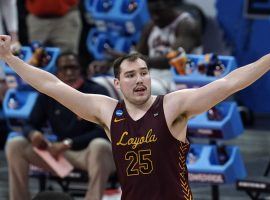 oyola Chicago senior big man Cameron Krutwig celebrates an upset victory over #1 Illinois in the second round of March Madness. (Image: Paul Sancya/Getty)