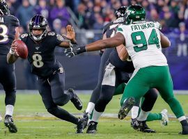 Baltimore Ravens QB Lamar Jackson evades New York Jets defenders at M&T Bank Stadium in Baltimore, MD. (Image: Getty)