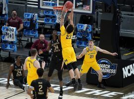 Michigan forward Brandon Johns dunks against Florida State in the Sweet 16 of March Madness. Michigan advanced to the Elite 8 as the only Big Ten team remaining in the tournament. (Image: Darron Cummings/AP)