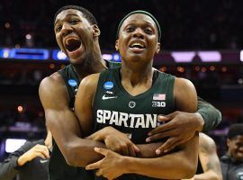 Michigan State forward Aaron Henry embraces guard Cassius Winston moments after Michigan State's victory over Duke in the March Madness Elite 8 game in Washington, DC. (Image: Patrick Smith/Getty)