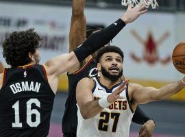 Denver Nuggets guard Jamal Murray, seen here slithering by Cleveland Cavs defender Cedi Osman, while scoring a career-high 50 points at the Pepsi Center in Denver. (Image: Tony Dejak/AP)