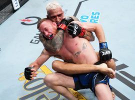 Charles Oliveira (back) submitted Justin Gaethje (front) in the first round of their main event clash at UFC 274. (Image: Getty)