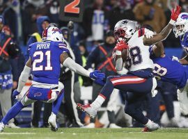 New England Patriots running back Rhamondre Stevenson evades a tackle from Jordan Poyer of the Buffalo Bills during a windy Monday Night Football matchup in Orchard Park, NY. (Image: Joshua Bessex/AP)