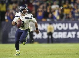 Seattle Seahawks quarterback Russell Wilson rolls out against the Los Angeles Rams at the LA Coliseum. (Image: Meg Oliphant/Getty)