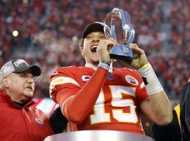 Kansas City head coach Andy Reid looks on as Patrick Mahomes hoists the AFC Championship trophy. (Image: Colin E. Braley/AP)