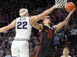 San Diego State guard Malachi Flynn shoots over Utah State guard Brock Miller in Logan, Utah. (Image: Eli Lucero/AP)