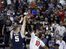 Utah State Aggies guard Sam Merrill (5) takes a game-winner shot over San Diego State defender KJ Feagin in the Mountain West Conference championship in Las Vegas. (Image: Isaac Brekken/AP)