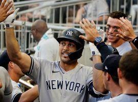 The New York Yankees dugout congratulates Giancarlo Stanton after he hit a home run against the Atlanta Braves. (Image: Getty)