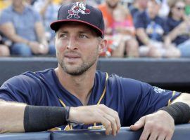 Tim Tebow stands in the dugout during the 2018 Eastern League All-Star Game. (Image: Julio Cortez/AP)