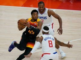 Donovan â€˜Spidaâ€™ Mitchell of the Utah Jazz splits a pair of LA Clippers, Kawhi Leonard (2) and Monte Morris (8) in Game 2 in Salt Lake City. Â (Image: Rock Browner/Getty)