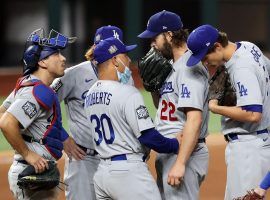 The Dodger gather around Clayton Kershaw en route to his second solid start in the 2020 World Series. (Image: AP)