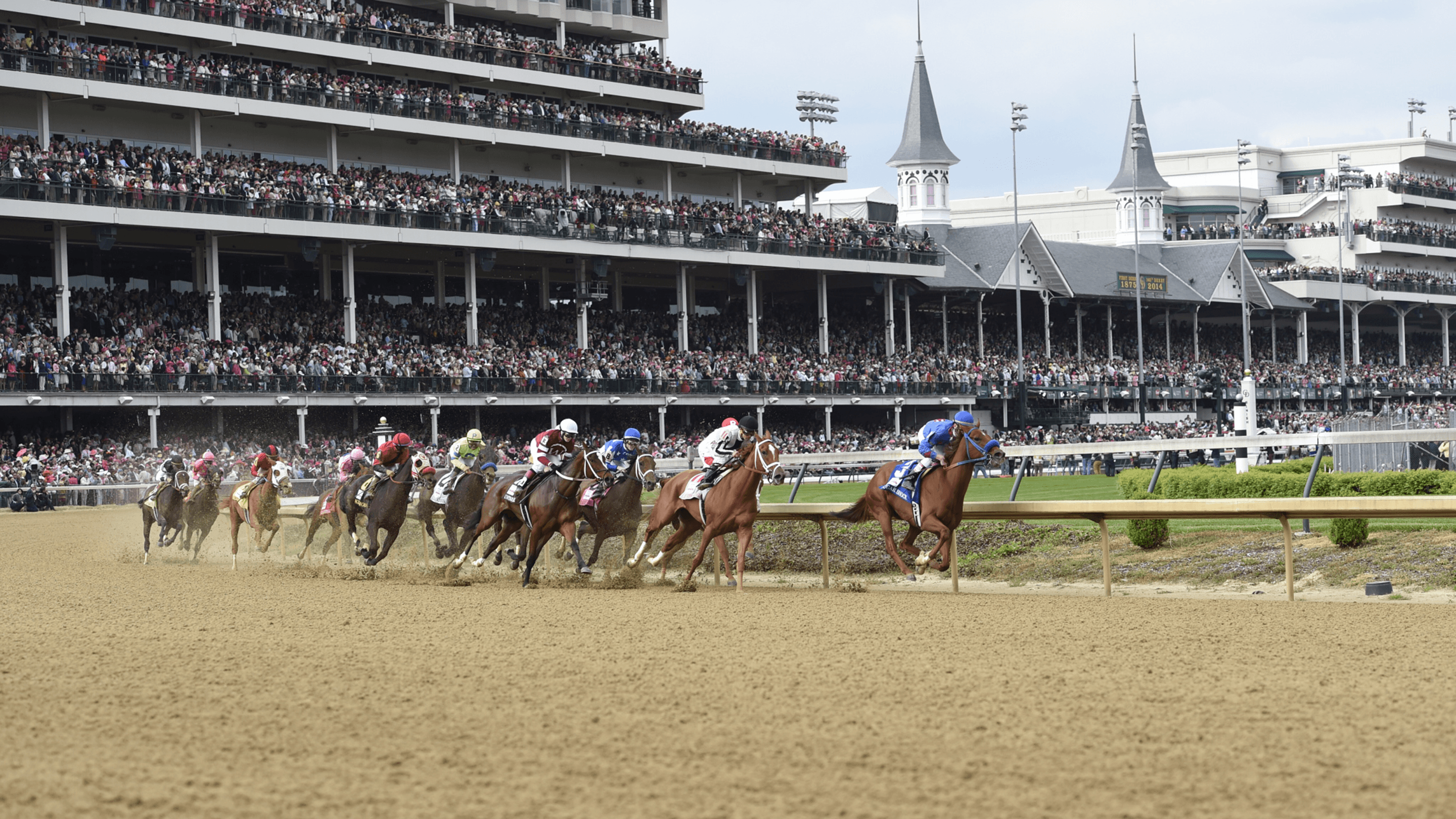 Derby horses round the first turn at Churchill Downs